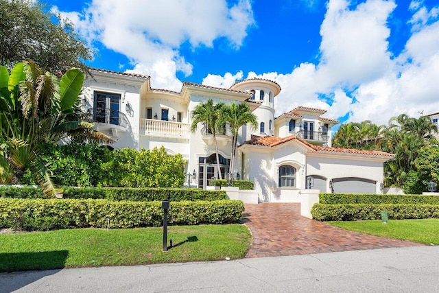 155 SE Spanish Trl, Boca Raton, FL 33432 - mediterranean / spanish home featuring stucco siding, decorative driveway, a tiled roof, and a front lawn