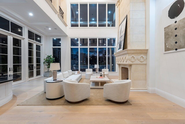 155 SE Spanish Trl, Boca Raton, FL 33432 - living room featuring a premium fireplace, wood finished floors, baseboards, and a high ceiling