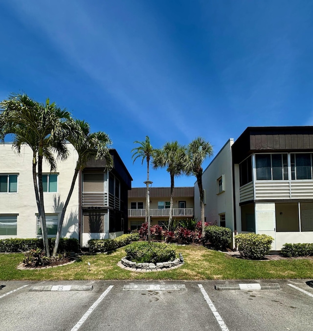 view of building exterior with uncovered parking