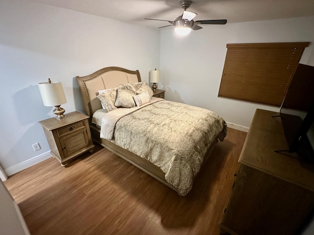 bedroom with wood finished floors, baseboards, and ceiling fan