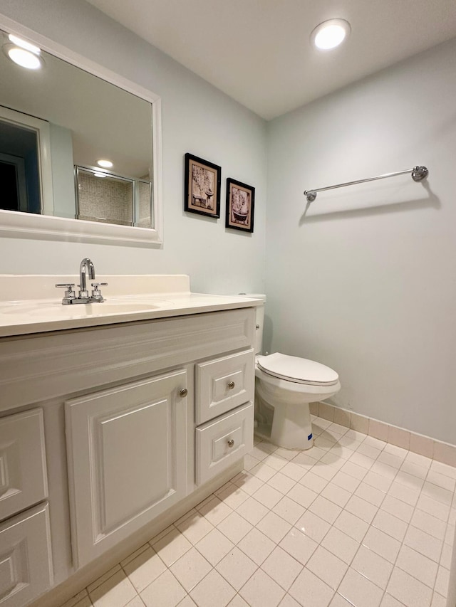 full bath featuring a stall shower, vanity, tile patterned floors, toilet, and recessed lighting