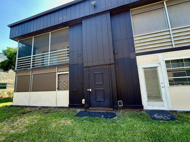 rear view of property with a lawn