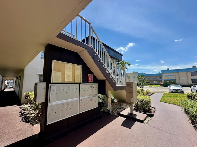 view of community with mail area and stairs