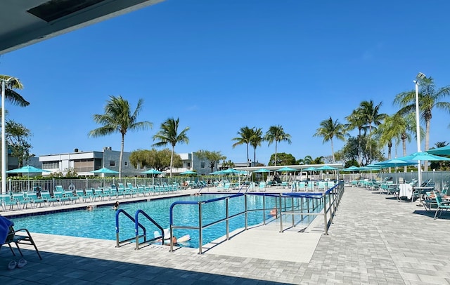community pool featuring fence and a patio