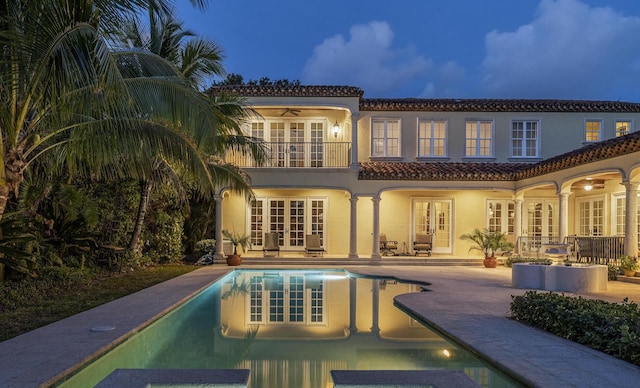 11 Wendy Ln, Stuart, FL 34994 - rear view of property featuring french doors, a balcony, a tile roof, a ceiling fan, and a pool with connected hot tub