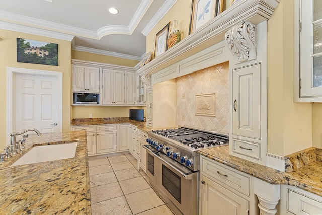 11 Wendy Ln, Stuart, FL 34994 - kitchen featuring range with two ovens, a sink, decorative backsplash, light stone countertops, and ornamental molding