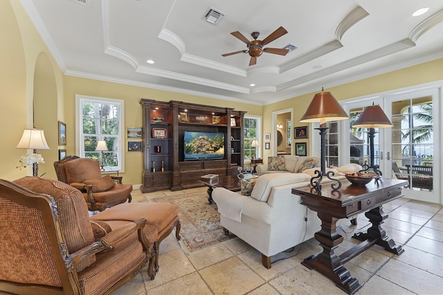 11 Wendy Ln, Stuart, FL 34994 - living area with a raised ceiling, ceiling fan, crown molding, arched walkways, and stone tile floors