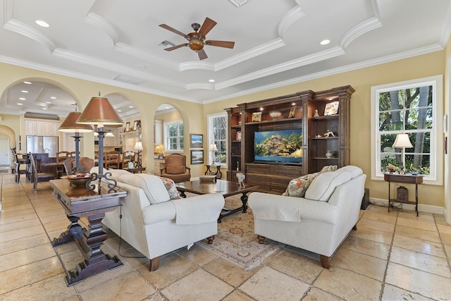 11 Wendy Ln, Stuart, FL 34994 - living area featuring a ceiling fan, arched walkways, baseboards, a raised ceiling, and crown molding