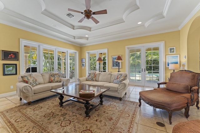 11 Wendy Ln, Stuart, FL 34994 - living room with french doors, ornamental molding, a ceiling fan, a tray ceiling, and arched walkways