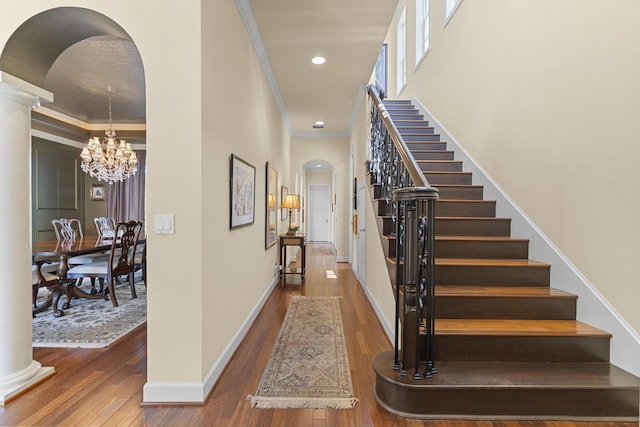 11 Wendy Ln, Stuart, FL 34994 - entrance foyer with arched walkways, stairway, wood-type flooring, recessed lighting, and ornamental molding