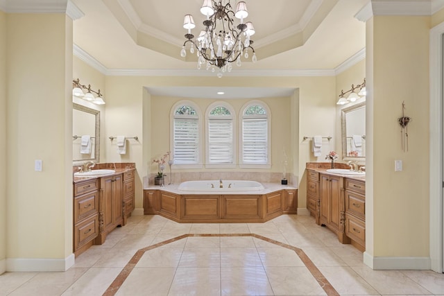 11 Wendy Ln, Stuart, FL 34994 - bathroom featuring two vanities, baseboards, a bath, a tray ceiling, and ornamental molding