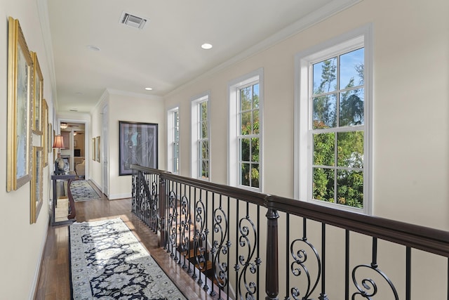 11 Wendy Ln, Stuart, FL 34994 - hallway with wood finished floors, ornamental molding, recessed lighting, baseboards, and an upstairs landing