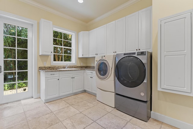 11 Wendy Ln, Stuart, FL 34994 - clothes washing area with cabinet space, separate washer and dryer, crown molding, and baseboards