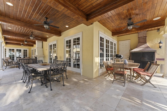 11 Wendy Ln, Stuart, FL 34994 - view of patio featuring french doors, outdoor dining space, exterior fireplace, and ceiling fan