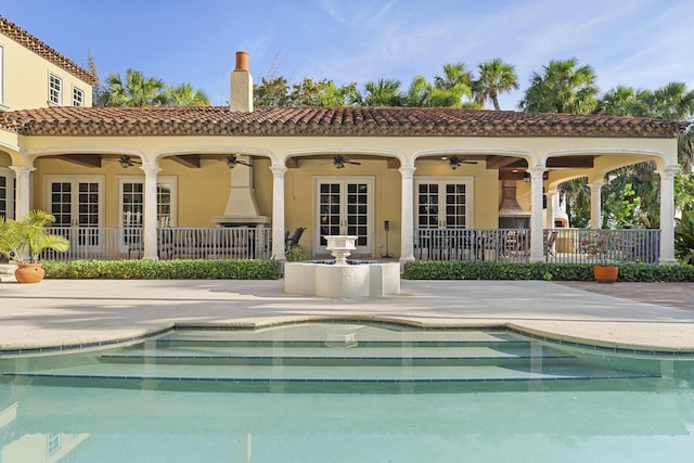11 Wendy Ln, Stuart, FL 34994 - rear view of house with french doors, a ceiling fan, a patio area, stucco siding, and a chimney