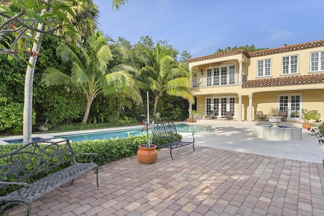 11 Wendy Ln, Stuart, FL 34994 - outdoor pool with french doors and a patio