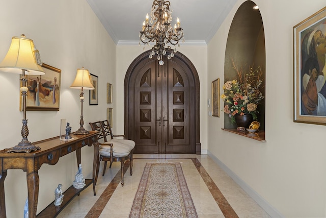 11 Wendy Ln, Stuart, FL 34994 - foyer entrance with arched walkways, inlaid floor details, a chandelier, baseboards, and ornamental molding