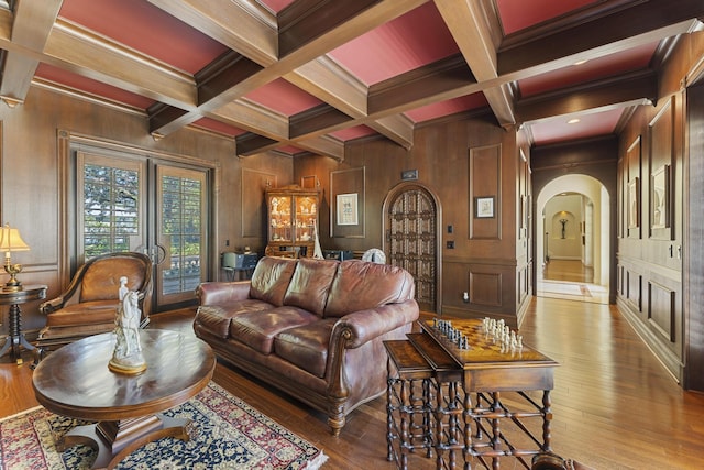 11 Wendy Ln, Stuart, FL 34994 - living area featuring arched walkways, hardwood / wood-style flooring, beam ceiling, coffered ceiling, and crown molding