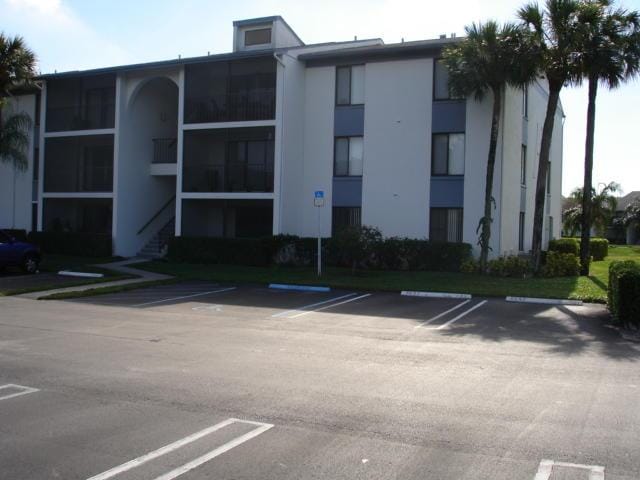 view of building exterior with uncovered parking