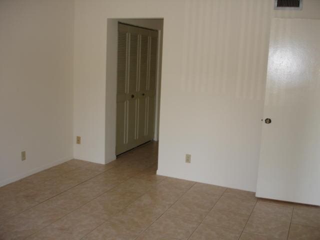 spare room with light tile patterned floors