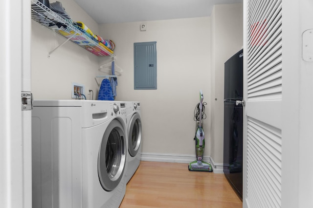 101 SE 20th Ave Unit 501, Deerfield Beach, FL 33441 - laundry area with electric panel, baseboards, washer and dryer, and wood finished floors