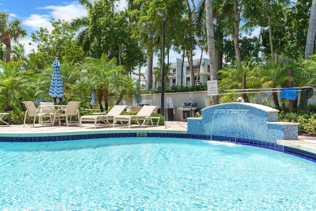 101 SE 20th Ave Unit 501, Deerfield Beach, FL 33441 - community pool with an outdoor kitchen, a patio area, and a grill