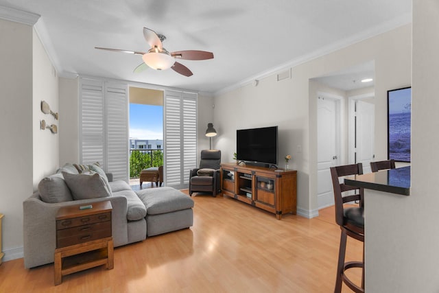 101 SE 20th Ave Unit 501, Deerfield Beach, FL 33441 - living area with crown molding, ceiling fan, light wood-style flooring, and baseboards
