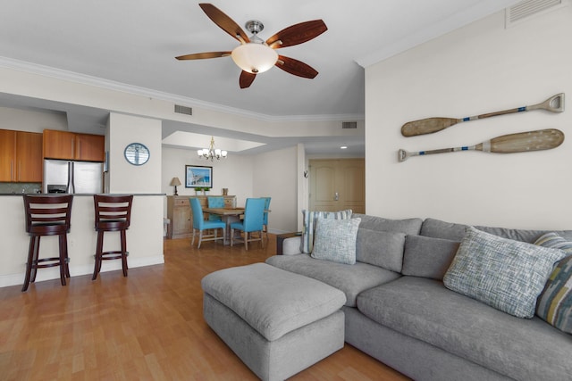 101 SE 20th Ave Unit 501, Deerfield Beach, FL 33441 - living room featuring ornamental molding, a chandelier, a ceiling fan, light wood finished floors, and baseboards