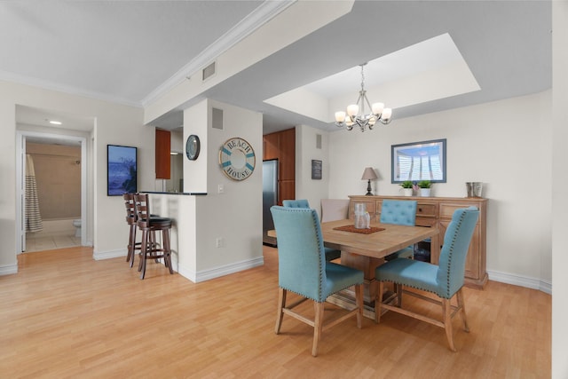 101 SE 20th Ave Unit 501, Deerfield Beach, FL 33441 - dining area with wood finished floors, baseboards, a chandelier, a raised ceiling, and ornamental molding