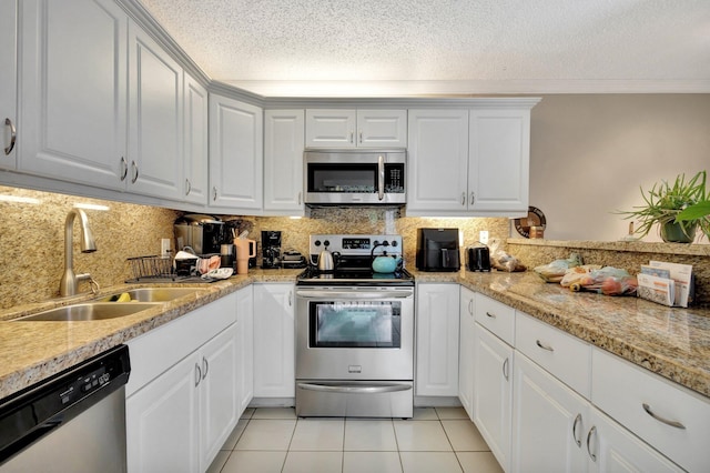 2950 SW 22nd Cir Unit 4C, Delray Beach, FL 33445 - kitchen featuring appliances with stainless steel finishes, a sink, a textured ceiling, light tile patterned floors, and tasteful backsplash