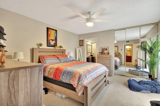 2950 SW 22nd Cir Unit 4C, Delray Beach, FL 33445 - bedroom with light carpet, ensuite bathroom, a ceiling fan, and a textured ceiling