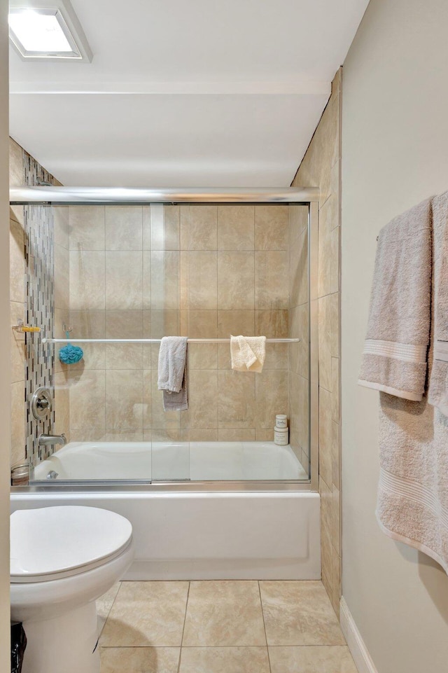 2950 SW 22nd Cir Unit 4C, Delray Beach, FL 33445 - full bathroom featuring tile patterned flooring, toilet, and bath / shower combo with glass door