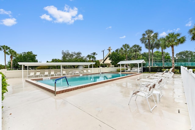 3001 SE Aster Ln Unit 908, Stuart, FL 34994 - community pool with fence and a patio area