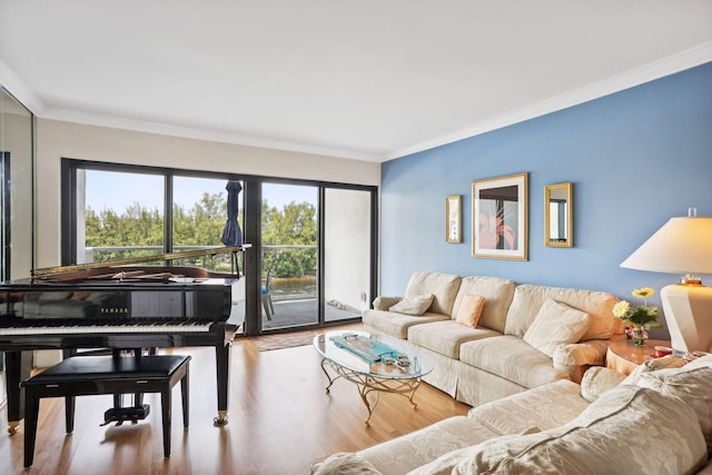 living area with ornamental molding and wood finished floors