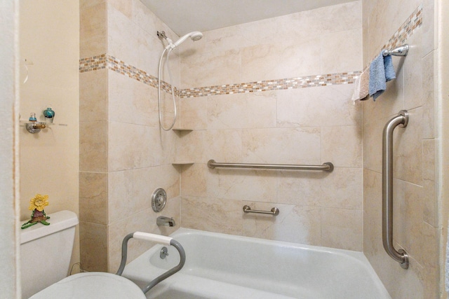 bathroom featuring toilet, tub / shower combination, and pet washing station
