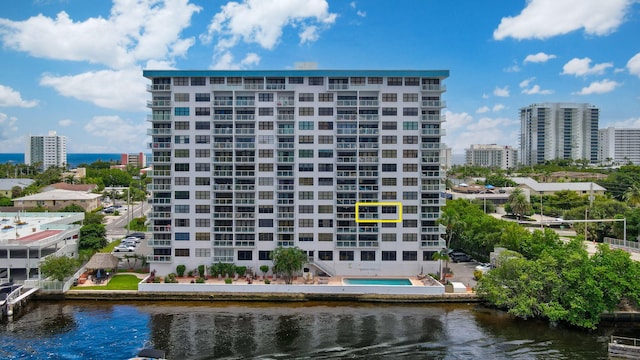view of apartment building / complex with a view of city and a water view