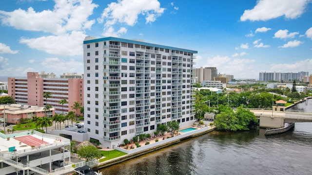 view of apartment building / complex featuring a city view and a water view
