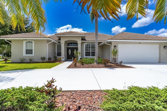 2904 SW Sutton Pl, Palm City, FL 34990 - mediterranean / spanish-style home with stucco siding, an attached garage, and a tiled roof