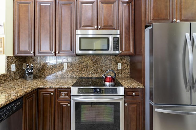 2904 SW Sutton Pl, Palm City, FL 34990 - kitchen featuring stainless steel appliances, decorative backsplash, and light stone countertops