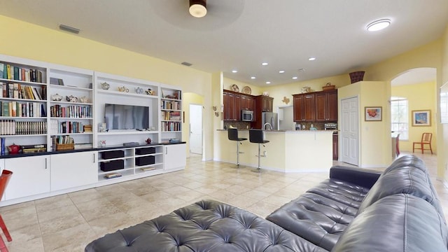 2904 SW Sutton Pl, Palm City, FL 34990 - living area featuring arched walkways, light tile patterned floors, recessed lighting, and ceiling fan