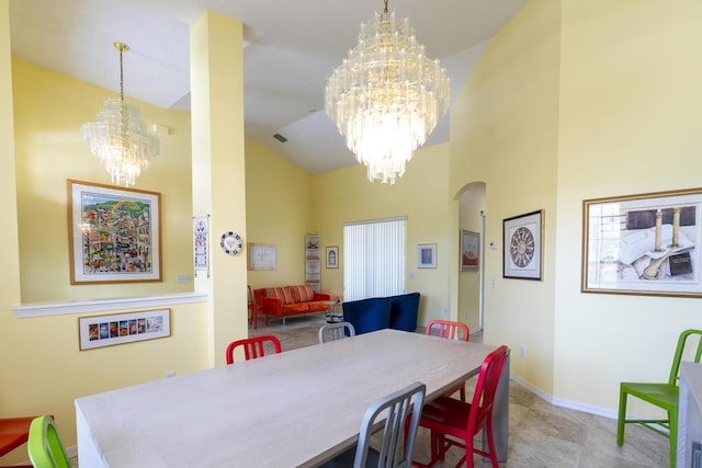2904 SW Sutton Pl, Palm City, FL 34990 - dining area with a chandelier, arched walkways, high vaulted ceiling, and baseboards