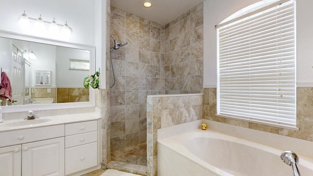 2904 SW Sutton Pl, Palm City, FL 34990 - bathroom with walk in shower, a garden tub, vanity, and tile walls
