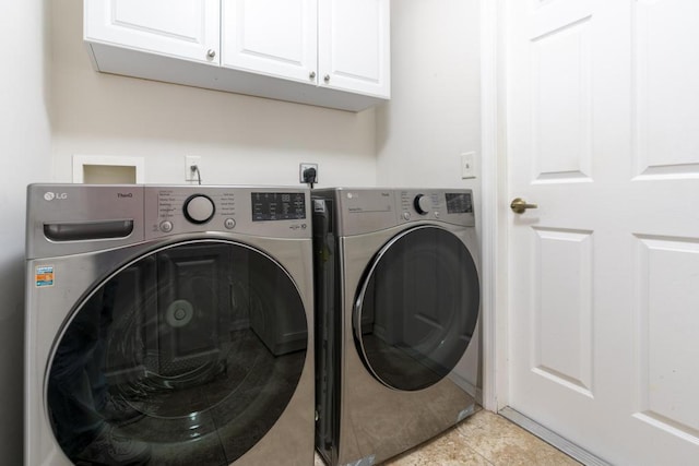 2904 SW Sutton Pl, Palm City, FL 34990 - washroom featuring cabinet space, washer and dryer, and light tile patterned floors