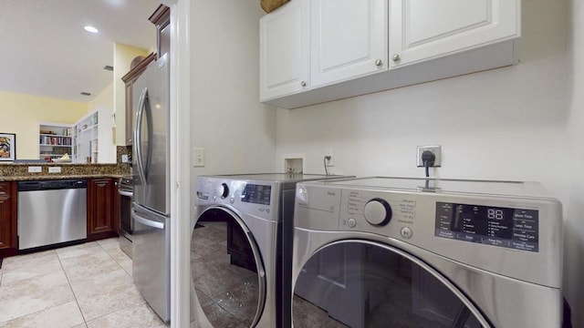 2904 SW Sutton Pl, Palm City, FL 34990 - laundry room featuring washing machine and clothes dryer, light tile patterned floors, recessed lighting, and cabinet space