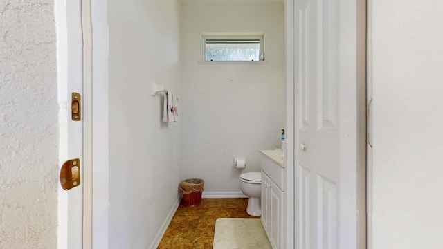 2904 SW Sutton Pl, Palm City, FL 34990 - bathroom featuring toilet, baseboards, and vanity