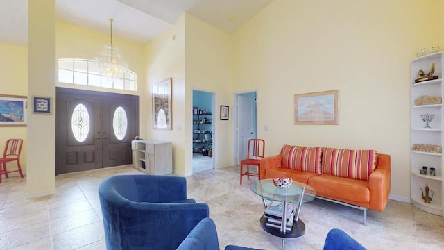 2904 SW Sutton Pl, Palm City, FL 34990 - entryway featuring high vaulted ceiling, a chandelier, baseboards, and light tile patterned floors