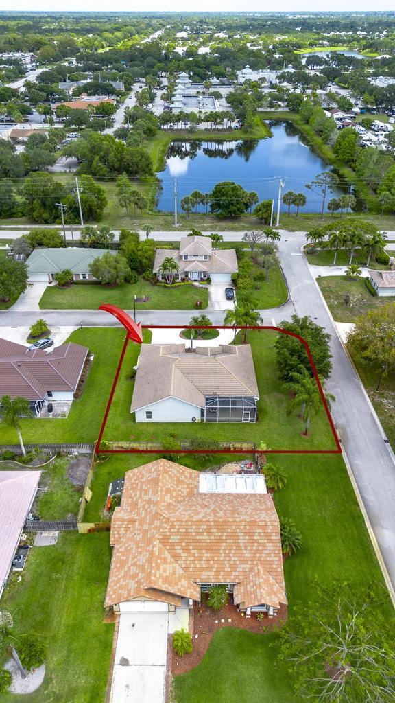 2904 SW Sutton Pl, Palm City, FL 34990 - aerial view of residential area featuring a nearby body of water and property boundaries highlighted