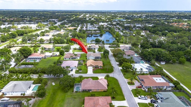 2904 SW Sutton Pl, Palm City, FL 34990 - aerial view of property and surrounding area featuring nearby suburban area and a large body of water