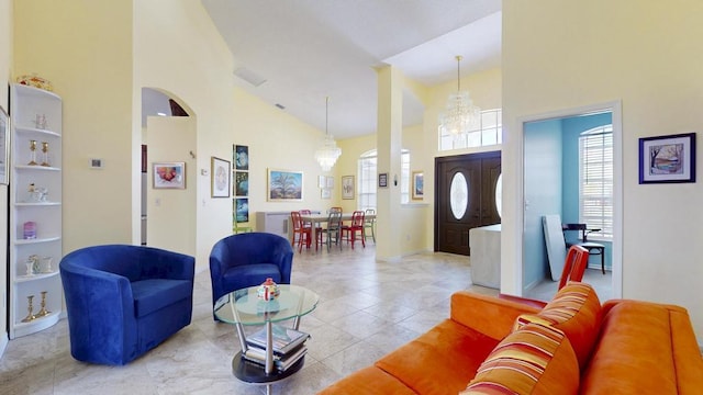 2904 SW Sutton Pl, Palm City, FL 34990 - living room featuring high vaulted ceiling, a chandelier, light tile patterned floors, and arched walkways