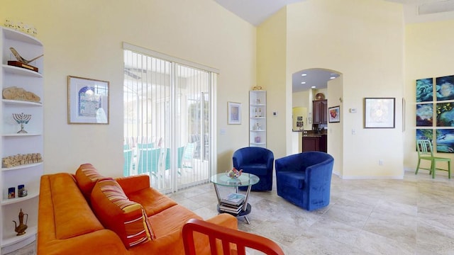 2904 SW Sutton Pl, Palm City, FL 34990 - living area with a high ceiling, arched walkways, baseboards, and built in features